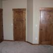 Master bedroom door with his and hers closet doors.